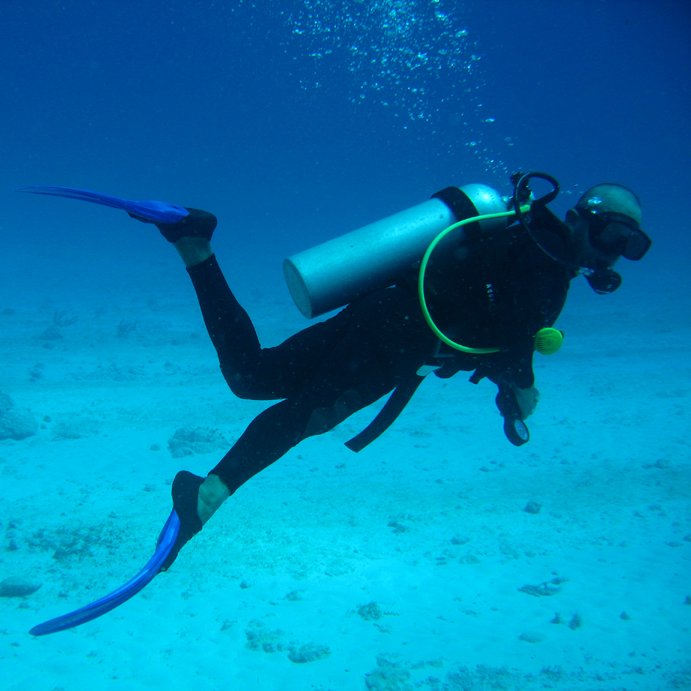 A scuba diver with all the appropriate equipment enjoying an expedition